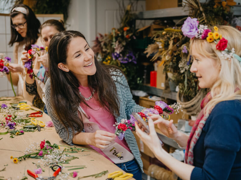 A hen party enjoy flower crown making.